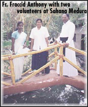 Fr. Fraccid ANthony wiht two volunteers at Sahana Medura