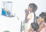Children in prayer at her home.