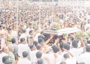 The city of gems was a sea of heads despite the rain yesterday as Ratnapura gave a final farewell to one of its great sons, Gamini Atukorale. The mourners led by Prime Minister Ranil Wickremesinghe included leaders of all parties. Pic by M. A. Pushpakumara