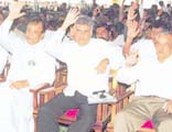 Prime Minister and UNP Leader Ranil Wickremesinghe, Deputy Leader Karu Jayasuriya and the party's new chairman, Malik Samarawickrema, seconding a proposal at the party convention yesterday at the Colombo Town Hall. Pic by Gemunu Wellage.