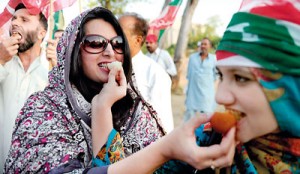 Supporters of Pakistani cricketer turned politician Imran Khan of Pakistan Tehreek-i-Insaaf (PTI - Movement for Justice) eat sweets while they celebrate following the verdict against Pakistani Prime Minister Yousuf Raza Gilani in Islamabad on June 19. AFP