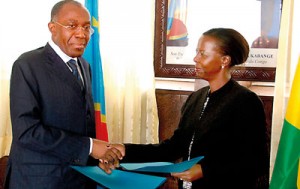 Rwandan Foreign Minister Louise Mushikiwabo (R) and her Congolese counterpart Raymond Tshibandaf exchange documents on June 19 during a meeting at the Foreign Ministry in Kinshasa. Mushikiwabo is visiting the Democratic Republic of Congo to discuss a mutiny in eastern DR Congo and allegations by Kinshasa that the mutineers have been trained in Rwanda.  AFP