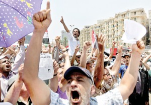 Focus on politics: Supporters of Egypt's first Islamist President Mohamed Mursi cheer at Tahrir Square in Cairo on Friday. Reuters