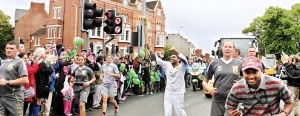 Exhilarating experience: Haresh carrying the Olympic Torch cheered by the crowd