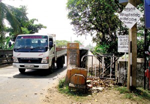 A sign board warns pedestrians of the parlous state of the bridge