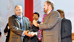 Dan Seneviratne (left) receiving his award