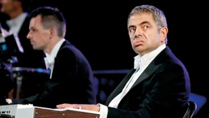 Looking bored: The London Symphony Orchestra played Chariots of Fire as Mr Bean - actor Rowan Atkinson - took to a keyboard