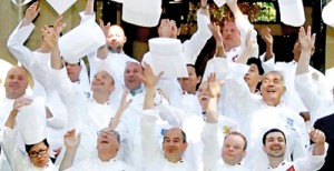 Members of the "club des chefs des chefs" throw their hats into the air before meeting in Paris. The club is made up of chefs to heads of states (Reuters)