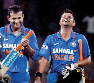 Irfan Pathan and Suresh Raina walk back to the pavilion after defeating Sri Lanka.   - Pix by Amila Gamage