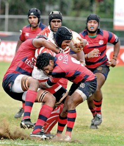 A CH player is brought down by the Red Shirts. - Pic by Ranjith Perera