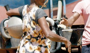 A woman pays for her pot of water