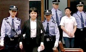 In the dock: Gu Kailai, 52, and aide Zhang Xiaojun, 33, are escorted into the Hefei City People's Court to face charges relating to the murder of British businessman Neil Heywood in November
