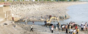 Desperate measures: Small waterways are being cut out of the empty Parakrama Samudra reservoir. Pic by K.G. Karunaratne