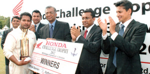 NDB Bank captain Rakitha Rupasinghe (in white) receiving the Honda Trophy from Chief Guest Dr. Kalinga Kaluperuma, Managing Director/CEO of Stafford Motor Company Pvt. Limited (third from right) others in the picture from left are R. Sujeeva de Silva (Secretary Tournament Committee), Mahesh Wijewardena (President) both from MCA, Charaka Perera General Manager Sales and Marketing Stafford Motor Company and Niran Mahawatte  VP/MCA.