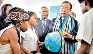 United Nations Secretary General Ban Ki-moon holds a globe as he speaks to East Timorese school children during a visit in Likisa on August 16. AFP