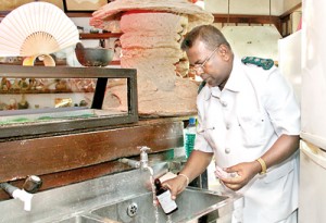 Officials checking the water at a city restaurant. Pic by Indika Handuwala