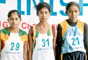 Winners of the Girls race:  Winner Dulanjali Amarasooriya of Sri Rahula College  Katugastota is flanked by Lasanthika Dilrukshi of Doragala MV Kotmale right and H.M.V. Seneviratne of Sri Rahula  College Katugastota (left).