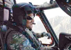 A smiling Suresh piloting a similar Black Hawk helicopter, in an undated photo, over the Kandahar mountains in Afghanistan