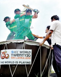 Workers putting the final touches to the ICC World T-20 cut-outs that have sprung up all over the island. Pic by Amila Gamage