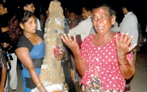 Shattered dreams: One of the pilgrims breaks down on their arrival at the BIA on Wednesday night. N. Kumarasinghe