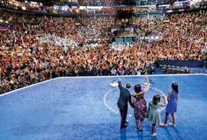 President Obama waves at supporters as he leads his family - wife Michelle, and daughters Sasha and Malia across the stage at the Democratic National Convention (REUTERS)