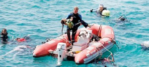 Tragedy: A diver cradles the body of a young girl after a boat carrying Syrian refugees trying to reach Europe capsized in waters off western Turkey. 58 people perished and 50 survivors managed to swim to shore,  which was just yards away