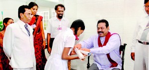 One of the students who obtained 3A’s receiving her award from His Excellency Hon. MahindaRajapaksha.