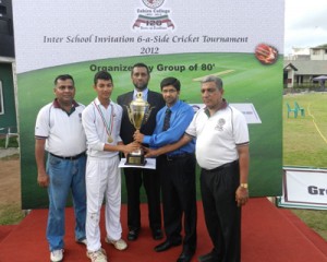 Zahira captain Wasim Sinnen receives the champion trophy from Fahim Gaffoor.