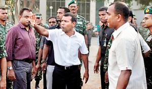 Mohamed Nasheed attempts to address protesting policemen, before announcing his resignation in capital Male during the political crisis in February.