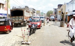 Driving through the half-repaired roads raise clouds of dust, making maneuvering difficult and causing traffic snarl-ups