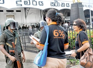 Taking over the police role, the Army has now been deployed for crowd control with their new gear as seen in this picture where striking university academics are explaining their cause to soldiers while they sell T-shirts with their protest slogans. Pic by Mangala Weerasekera