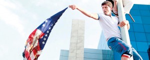 Tunisian protesters replace a U.S. flag with an Islamic flag  outside the U.S. embassy in Tunis, during a demonstration against a film deemed offensive to Islam (AFP)