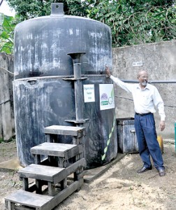 Mr. Tissera stands beside his ravenous invention.