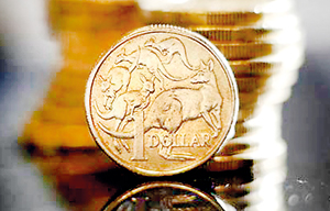 Australian one dollar coins are displayed in this photo (Reuters)