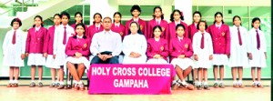 The champion Holy Cross team: Seated (from left): Shehani Modaragama, Mahesha Ekanayake (Coach), Rev Sister Mary Deepani (Principal), Ashini Navoda (Captain), Petronilda Biyanwala (Vice Captain). Standing (from left): Poornavi Harshika, Salini Dias, Dilushi Hasinika, Hashini Chamodya, Januli Thinara, Dakshina Nishani, Tharushi Ishara, Anuki Viveka, Hansani Jayasinghe, Manesha Dilakshi, Dinithi Dias, Oshadee Karunaratne, Oavani Navodya, Thehani Sanjula, Nethni Himasha.