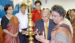 Sumithra Peiris and Dr. Lester James Peiris lighting the traditional oil lamp