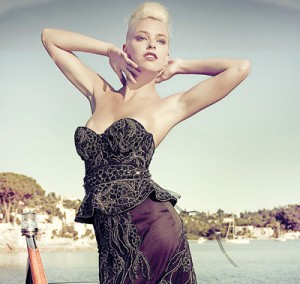 Posing on the back of a luxurious yacht, a model shows off the dress, which was created by fashion designer Debbie Wingham