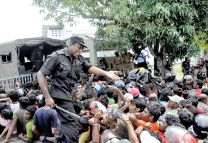 It’s a near stampede for tickets at the Sport Complex at Thurstan College as Cricket-crazy Lankans get news of the sale of 3,000 tickets. Pix by Indika Handuwala and Amila Gamage