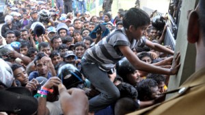 T-20 cricket has enveloped the entire island. This picture captured by Amila Gamage shows the scramble for tickets for the Sri Lanka, Pakistan semi-final on Thursday. There was pandemonium even, yesterday when the last lot of the final match tickets were released.