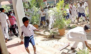 Young schoolboys get ready with pebbles. Pix by K.D. Sugathapala