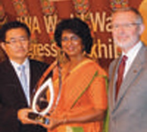 Ms. Athukorala receiving the award from IWA World Water Congress President Prof. Changwon Kim, with IWA President Dr. Glen Daigger on her left.