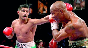 Amir Khan throws a jab at Zab Judah. AFP.