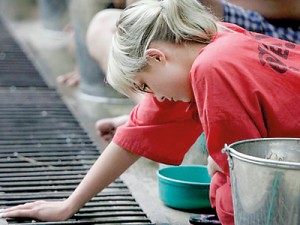 'Hell on earth': A Western drug addict pauses over the trough during induced vomiting to detoxify her body at the Tham Krabok monastery in Thailand