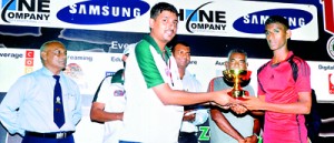 The skipper of St. Mary’s College Kegalle, T.U.D. Dharmawardana receiving the Plate trophy from M. Sharaf, Executive of Akbar Brothers