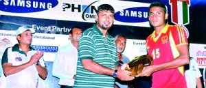 Skipper of St. Thomas College Matara, Rasika Sampath receiving the Shield title from Raja Manikkam, Director of Little Asia