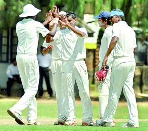 Thomians celebrate a wicket. Pics by Amila Gamage