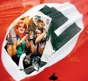 Protesters with burning Nazi flags greeted German Chancellor Angela Merkel as she arrived in Greece earlier this year .It was Merkel’s first visit since the Eurozone crisis hit Greece three years ago (REUTERS)