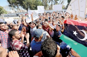 Libyan protesters from the city of Bani Walid shout slogans during a protest outside the National Congress in Tripoli on October 7, 2012 against the decision of the National Congress besieging their city. Libyan efforts to arrest the killers of a man credited with capturing late leader Moamer Kadhafi have turned into a siege of the city of Bani Walid. AFP