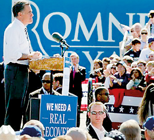 US Republican presidential candidate Mitt Romney (L) speaks to supporters at a rally (AFP)