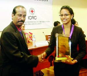 Dean of the Faculty of Law, University of Colombo, Mr V.T. Thamilmaran congratulates Lead Counsel of APIIT Law School team, Dilhara Gunaratne.— at Senate Room, College House, University of Colombo.